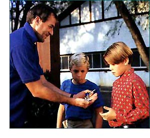 Man giving candy to kids