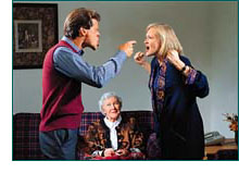 Husband and wife arguing with old lady smiling on